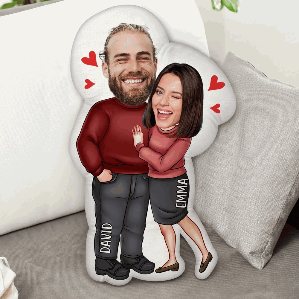A couple caricature pillow on a sofa